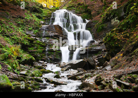 Beautiful view of the waterfall in the beech forest in the golden autumn season. Stock Photo