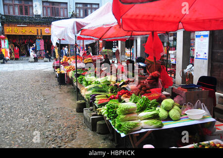 Street markets selling fruits and vegetables are found in the Zhenyuan Ancient Town in China's Guizhou Province. Stock Photo
