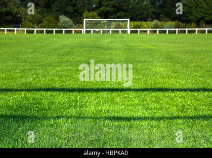 Grassy Field And Goal Post On Sunny Day Stock Photo