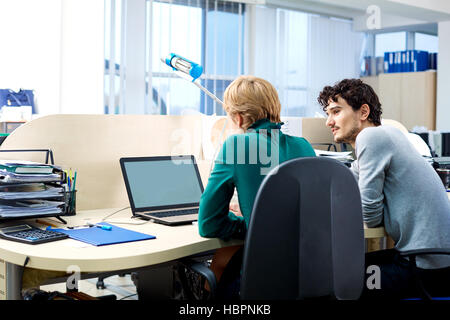 Back view. Business people working at the desk in the office. Stock Photo
