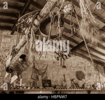 Traditional Cypriot farming tools used as decoration in an old house in the mountain village of Lofou in Limassol District. Sepia toned. Stock Photo