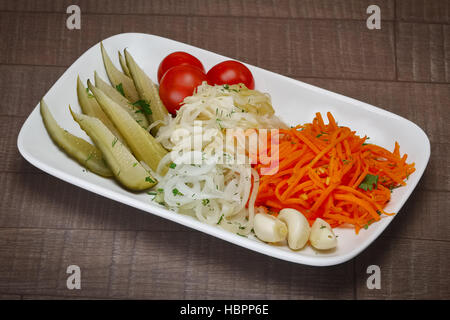 Pickled cucumber, cabbage and garlic with fresh onion and tomato. Stock Photo