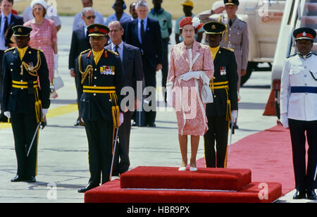 Queen Elizabeth II standing on the red carpet with a party of dignitaries before her departure at Grantley Adams International Airport, Barbados Stock Photo