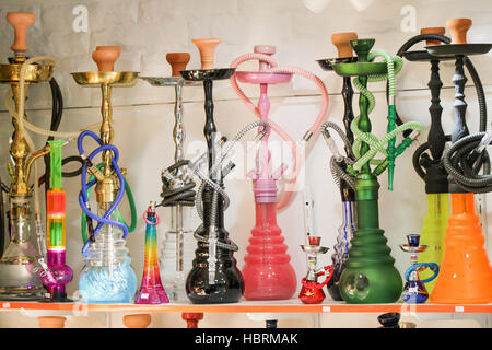 Group of eastern hookahs placed of various colors on a shelf Stock Photo