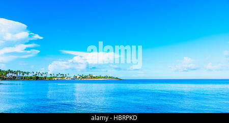 sandy beach and calm blue sea surf Stock Photo