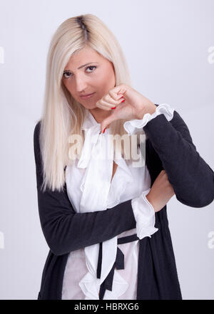 Half-length portrait of thumbing down girl, isolated on white Stock Photo