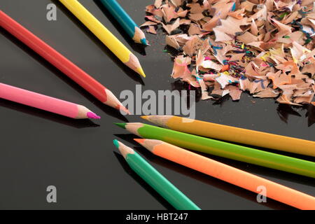 Sharpened colorful pencils and shavings Stock Photo