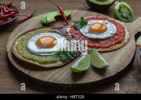 Variety of colorful mexican cuisine breakfast dishes on a wooden table Stock Photo