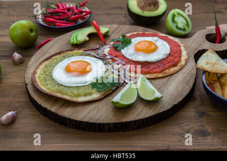 Huevos divorciados, delicious food with eggs, fresh salad and herbs  spicy  herby sauce Stock Photo