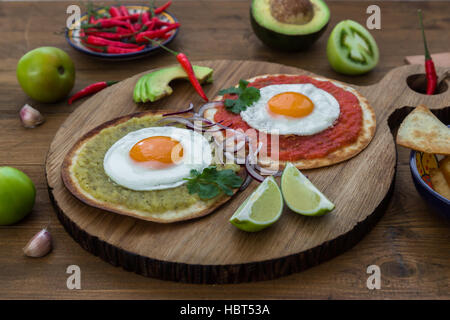 Huevos divorciados, delicious food with eggs, fresh salad and herbs  spicy  herby sauce Stock Photo