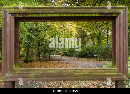 View through large hollow picture frame of trees and walking people at Leases Park in Newcastle, England Stock Photo