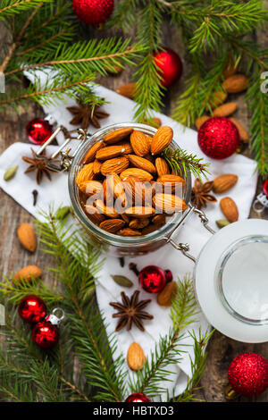 Jar full of almonds with festive Christmas background Stock Photo