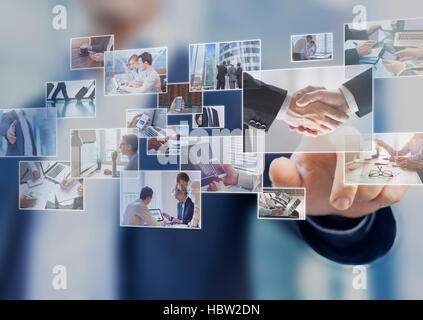 Businessman touching a photo on a digital screen interface, abstract images of business situations Stock Photo