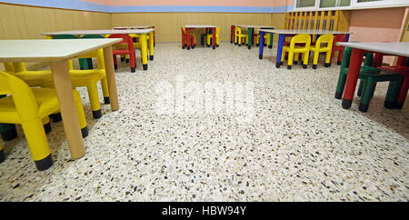 tables and chairs in the classroom of a school for children Stock Photo