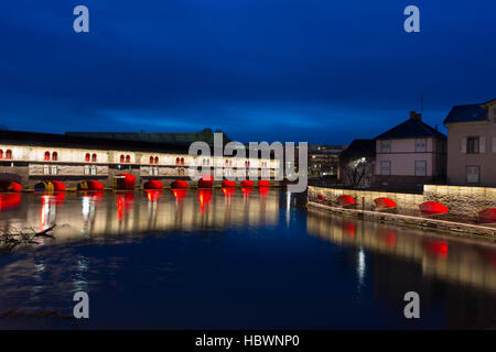 illumined Ponts Couverts and Barrage Vauban at twilight reflected in the waters on the River Ill, Alsace France Stock Photo