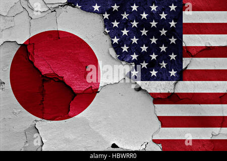 flags of Japan and USA painted on cracked wall Stock Photo