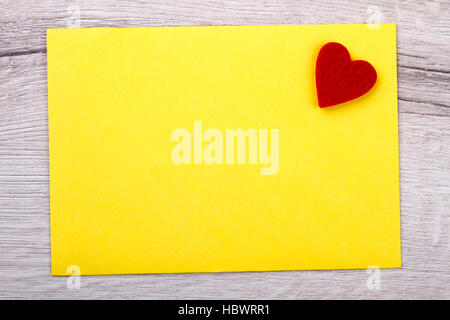 Yellow paper and heart. Stock Photo