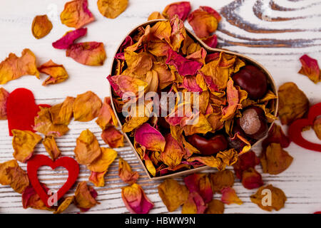 Heart-shaped box with rose potpourri. Stock Photo