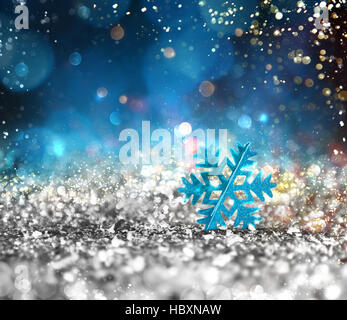 Silver sparkly crystal with snowflake background Stock Photo