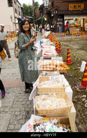 Thai woman visit and buy snack and candy alley japanese style called Kashiya Yokocho at Kawagoe town is also known as Little Edo on October 19, 2016 i Stock Photo