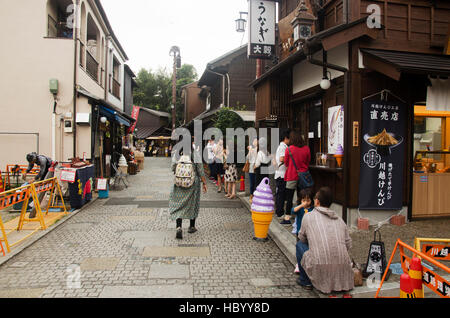 Thai woman visit and buy snack and candy alley japanese style called Kashiya Yokocho at Kawagoe town is also known as Little Edo on October 19, 2016 i Stock Photo