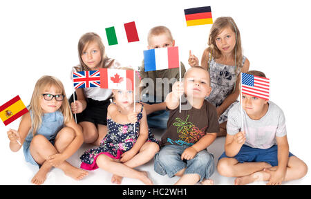 poland group holding flags of different countries. German flag, flag england, spain, america, russia, france flag, canada Stock Photo