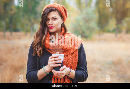 http://l450v.alamy.com/450v/hc31rt/young-beautiful-girl-with-a-cup-of-coffee-tea-for-a-walk-in-the-park-hc31rt.jpg