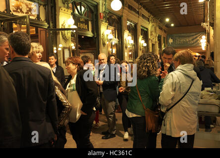 Visitors socialize in the arcade outside Cafe Iruna, the historic cafe in Pamplona, Spain, made famous by Ernest Hemingway in The Sun Also Rises. Stock Photo