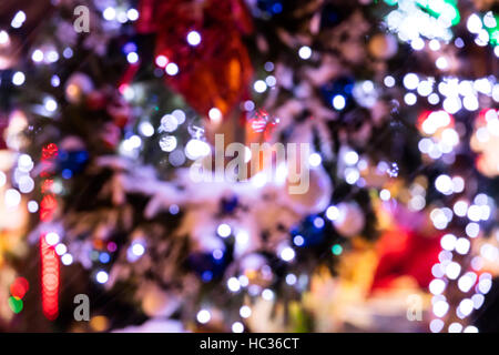blurred strings of christmas lights illuminating night city on new years eve Stock Photo