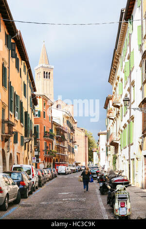 VERONA, ITALY - OCTOBER 10, 2016 - via Sottoriva street and view of Sant'Anastasia Church tower in old town Verona. Verona is second largest city muni Stock Photo