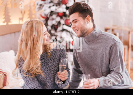 Delighted young couple celebrating New Years Eve Stock Photo