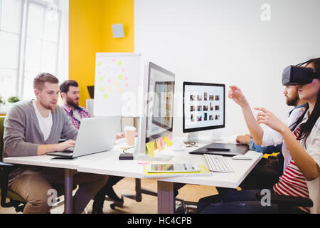 Female editor using augmented reality headset at creative office Stock Photo