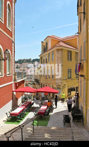 LISBON, PORTUGAL - MAY 13, 2011: Outdoor cafe on the old street of central Lisbon. Stock Photo