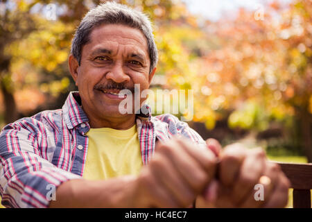 Portrait of elderly man sitting on the bench Stock Photo