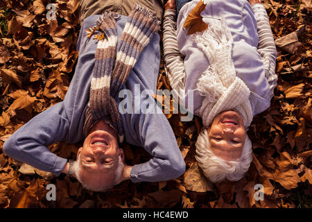 Senior couple lying on the ground Stock Photo
