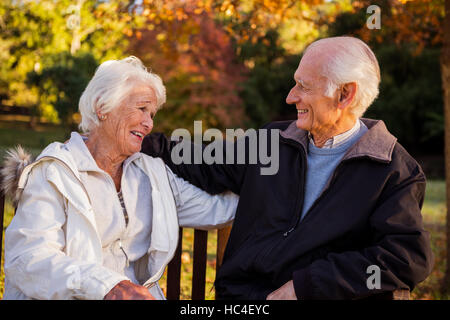 Senior couple embracing on a bench Stock Photo