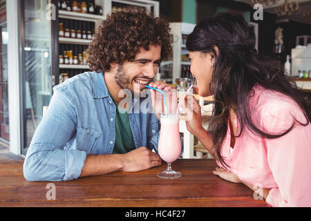 Happy couple drinking milkshake Stock Photo
