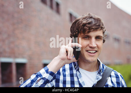Smiling student talking on mobile phone Stock Photo