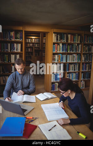 Mature students working together in college library Stock Photo