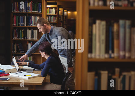 Mature students working together in college library Stock Photo