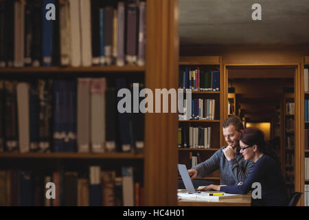 Mature students working together in college library Stock Photo