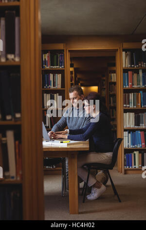 Mature students working together in college library Stock Photo