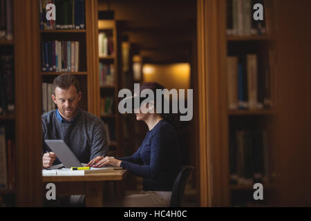 Mature students working together in college library Stock Photo