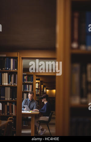 Mature students working together in college library Stock Photo