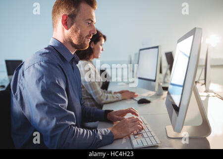 Mature student using computer Stock Photo