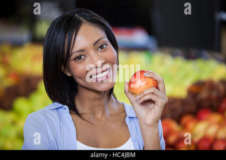Portrait of beautiful woman holding an apple Stock Photo
