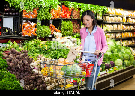 Woman buying vegetables in organic section Stock Photo