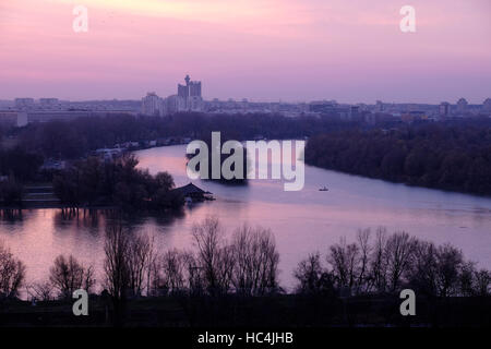 View at sunset toward New Belgrade across the confluence of the Sava river into the Danube in the city of Belgrade capital of the Republic of Serbia Stock Photo