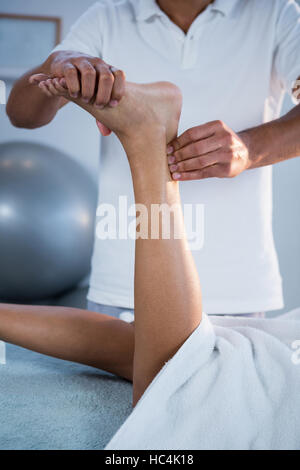 Woman receiving foot massage from physiotherapist Stock Photo
