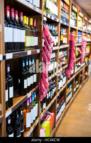 Variety of wine bottles in grocery section Stock Photo